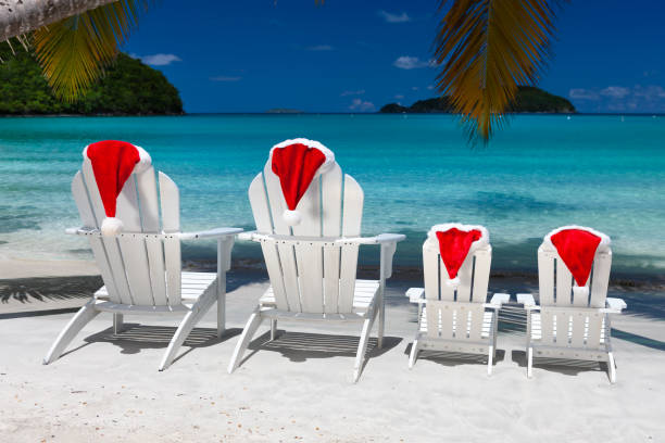 istock Adirondack chairs and palm trees with Christmas hats on a tropical beach 1277331886