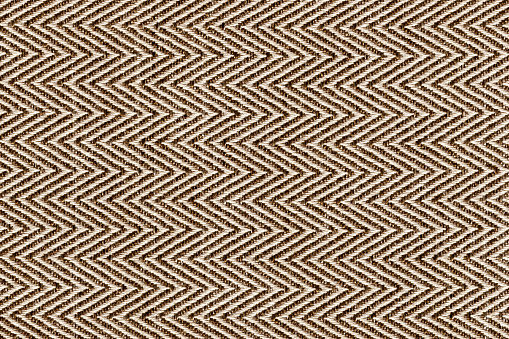 Oro, beige con colores marrones tela muestra Herringbone, telón de fondo de textura patrón en zigzag. Línea de la tira de la tela, diseño del patrón de la espina de la pared, tapicería para el fondo del diseño interior de la decoración. photo