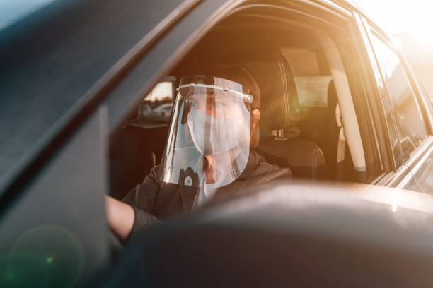 istock Female taxi driver with protective face mask and plastic visor 1277335692