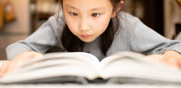 istock Girl reading a book seriously 1277340998