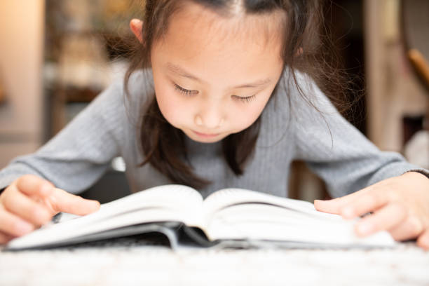 istock Girl reading a book seriously 1277341012