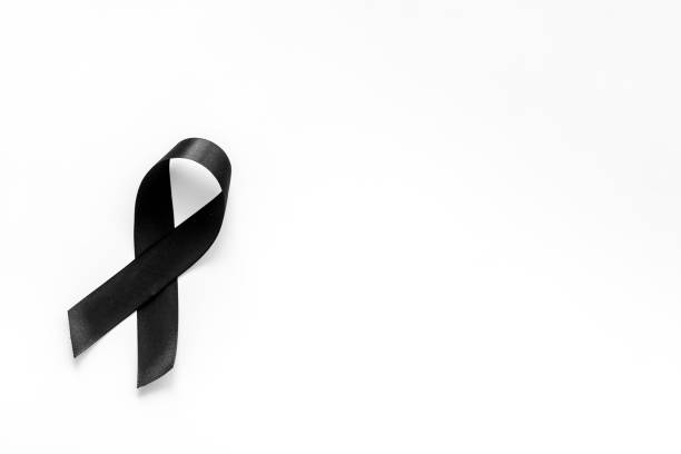 istock Black ribbon as mourning symbol top view 1277341137