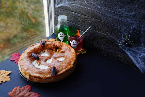 istock pumpkin pie with multi coloured drinks on window sill. autumn seasonal composition. fall time, thanksgiving and halloween concept 1277341231