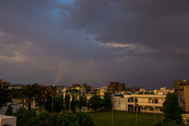 urban city scape on rainy day with beautiful clouds and a thin rainbow