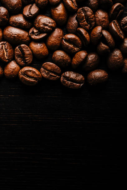 istock Coffee beans on wooden background. 1277342208