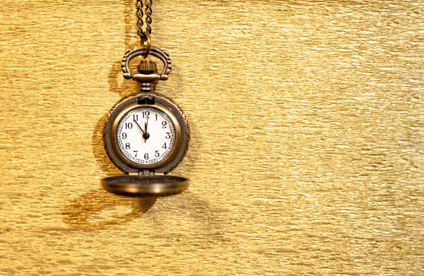 The antique clock shows almost midnight on a sparkling gold background. New year concept. The antique clock shows almost midnight on a sparkling gold background. New year concept. Place for text. its almost time stock pictures, royalty-free photos & images
