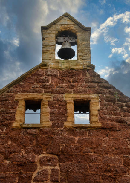 An old Bell tower pictured against a moody sky