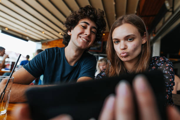istock Young couple having fun in sidewalk cafe 1277345578