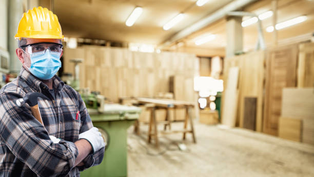 istock Carpenter at work protects the face with the surgical mask. Carpentry. Covid-19 prevention. 1277346566