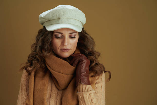 istock young woman in sweater on bronze background 1277347188