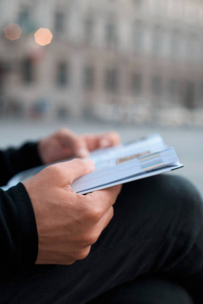 istock man reading a book on the street 1277348781