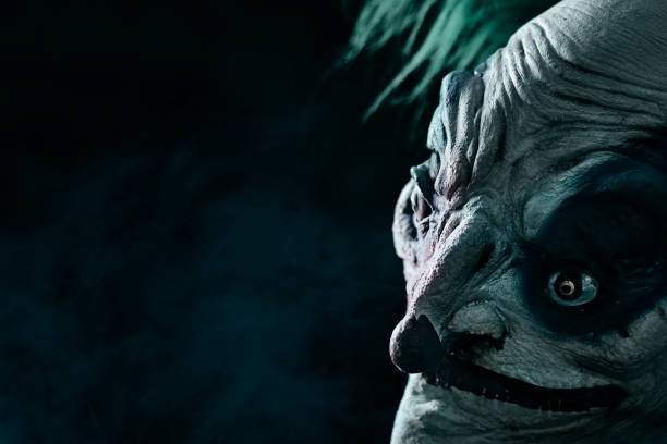 istock disturbing evil clown wearing a face mask 1277348859