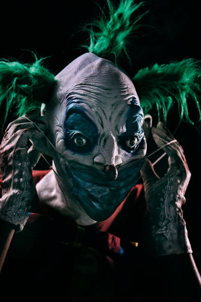 istock disturbing evil clown wearing a face mask 1277349028