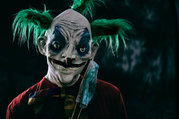 istock disturbing evil clown wearing a face mask 1277349121