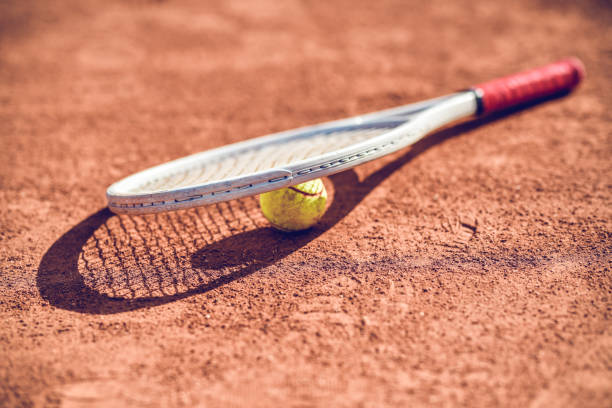 istock Tennis Ball And Racket Lying Down On Court 1277350473