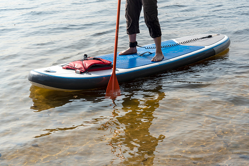 Standup paddleboarding are on the river Moscow, Strogino. The concept of a healthy lifestyle.