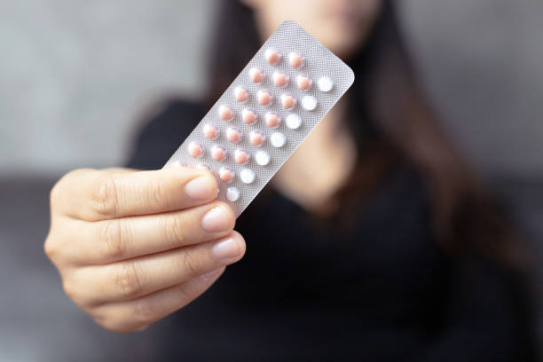 Women carry birth control pills, focus Hand stock photo