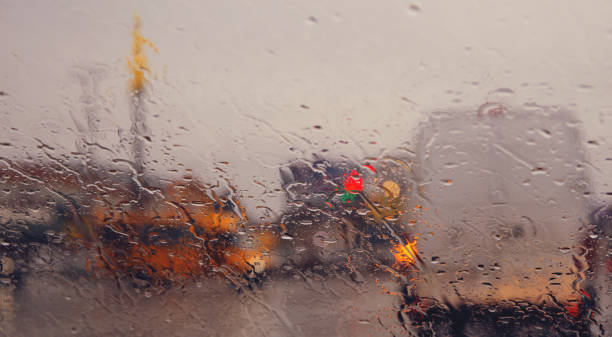 istock City road seen through rain drops on the car windshield. 1277356746