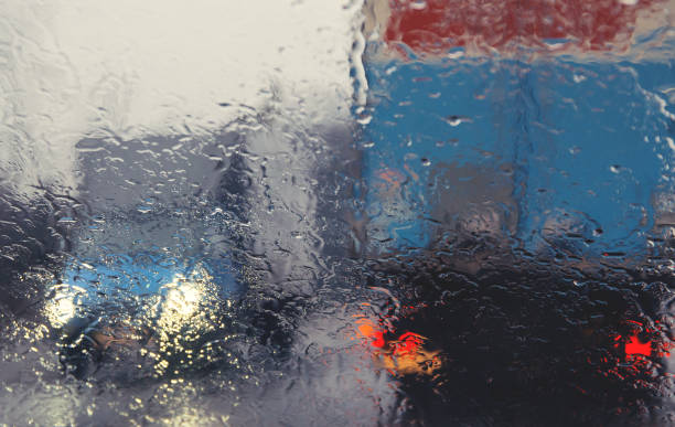 istock City road seen through rain drops on the car windshield. 1277356751