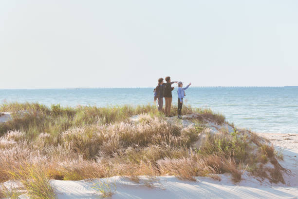 istock Friends hiking, exploring and viewing the ocean 1277357033