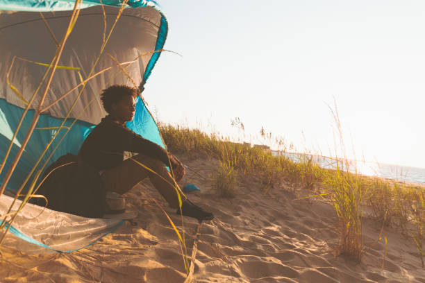 istock Teen boy camping and viewing the ocean 1277357034