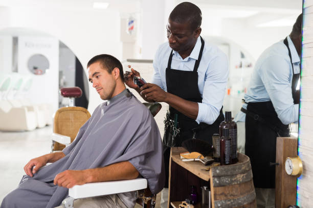 istock African hairdresser doing styling for young man 1277357482