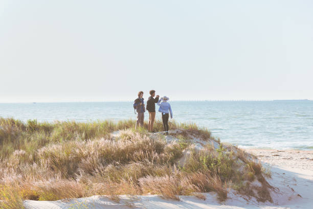 istock Friends hiking, exploring and viewing the ocean 1277358533
