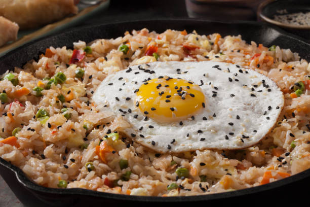 istock Spicy Korean Kimchi Fried Rice with a Fried Egg and Spring Rolls 1277359889