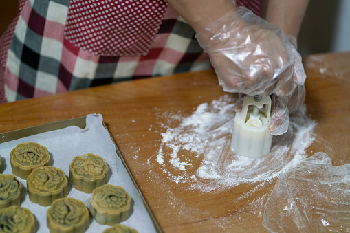 An Asian woman makes moon cakes for the Mid-Autumn Festival