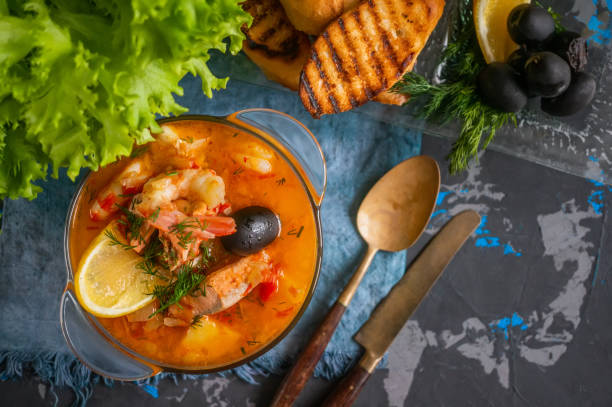 istock Seafood soup, salmon and cod with potatoes. Served with lemon and olives. Close up. 1277365372