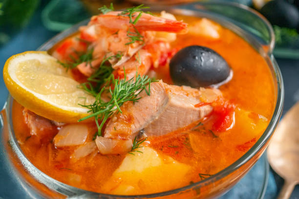 istock Seafood soup, salmon and cod with potatoes. Served with lemon and olives. Close up 1277365385