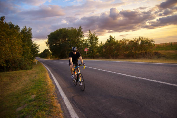 istock Man cycling on the road 1277365954
