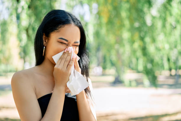 istock African american woman blows her nose into a tissue 1277366812