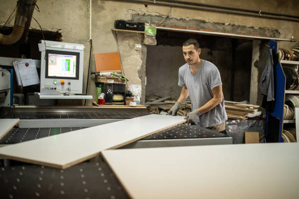 istock Manual worker using CNC machine for wood processing in woodworking company 1277366873