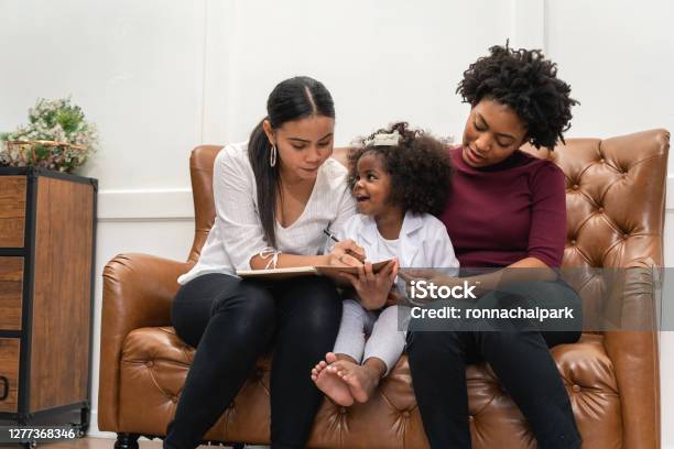 Lgbt Diversity Lesbian Couple Moments Happiness With Her African Girl Laughing And Drawing Picture Lgbt Lifestyle Stock Photo - Download Image Now