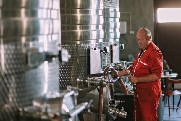 istock Employee takes a sample from a stainless steel fermentation tanks 1277372155