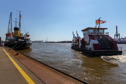 A ferry is leaving at the museum harbor of Oevelgoenne on the river Elbe in Hamburg, Germany