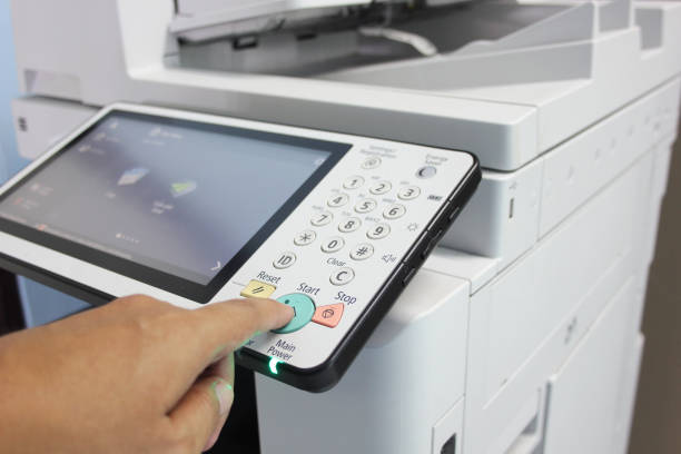 istock Bussiness man Hand press button on panel of printer, printer scanner laser office copy machine supplies start concept. 1277372839