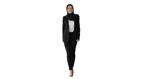 Wide shot. Front view. Smiling islamic female model wearing hijab walking and looking ahead on white background. Professional shot in 4K resolution. 043. You can use it e.g. in your medical, commercial video, business, presentation, broadcast