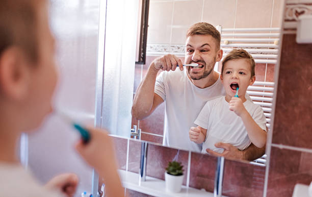 istock Father And Little Son Brushing Theet 1277373546