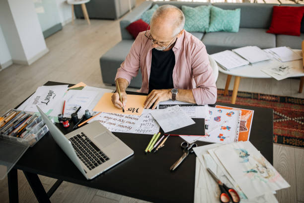 istock Senior calligraphy artist working at his home office 1277373744