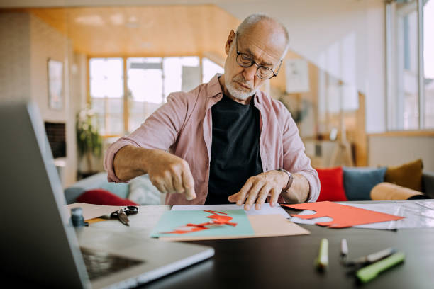 istock Senior artist working on his collage art piece 1277373853