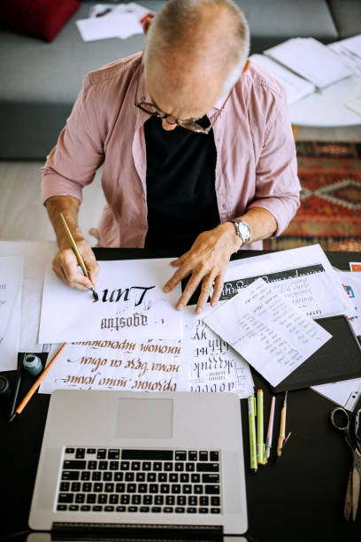 istock Artist writing calligraphy  in his home office studio 1277373860