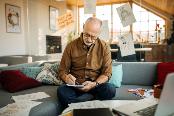 istock Senior artist on creating art on his sofa at his home office 1277373946