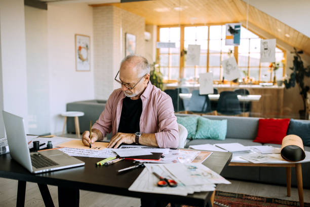 istock Senior calligraphy artist working at his home office 1277374107