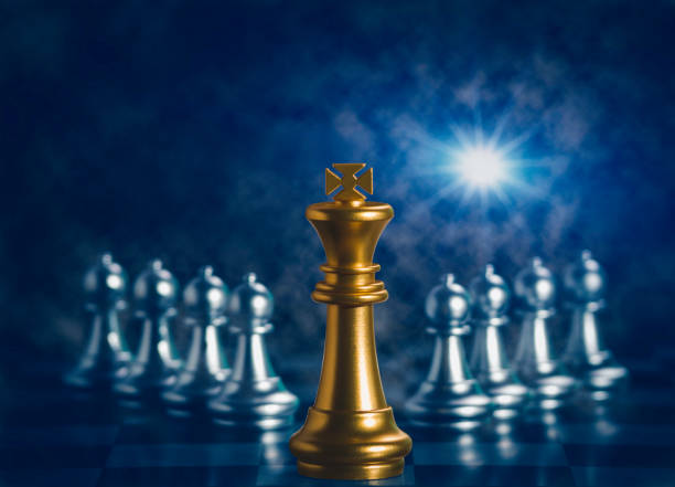 istock Golden king chess is surrounded by falling around silver chess pieces  to fighting with teamwork to victory, business strategy concept and leader and teamwork concept for success. 1277375408