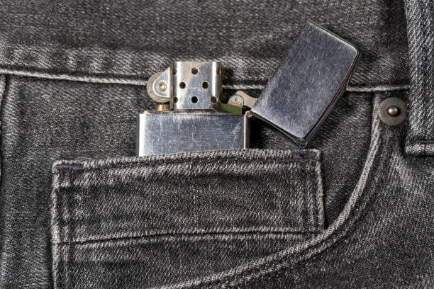istock Closeup to brushed chrome lighter with windproof over black jeans. Amazing quality and durability. 1277375658