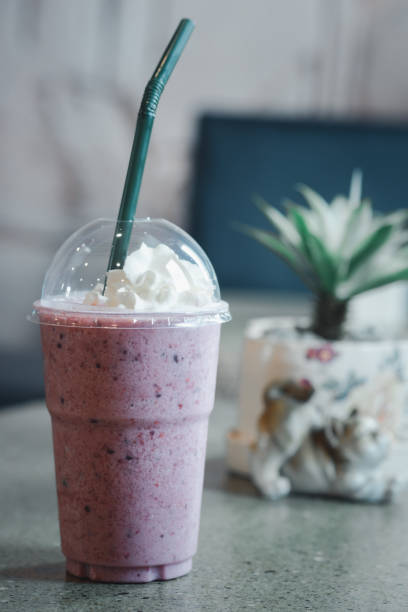 istock Blueberry smoothie yoghurt with whipped cream in plastic glass 1277376683