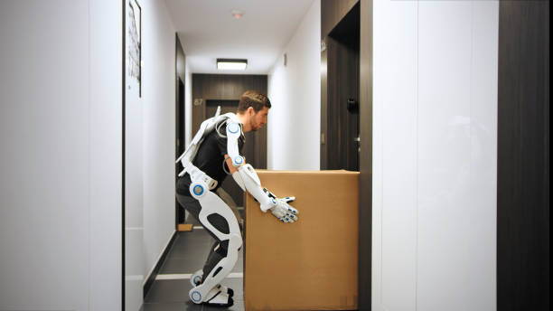 istock Proffesional mover in exoskeleton. Carrying heavy boxes along the hall 1277377043