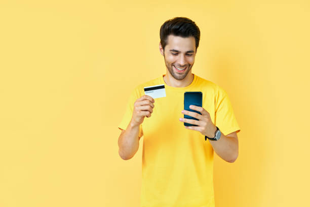 istock Young handsome man shopping online with credit card using smart phone 1277377519